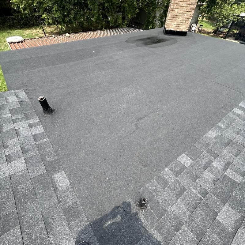 Flat roof black membrane installation with vents