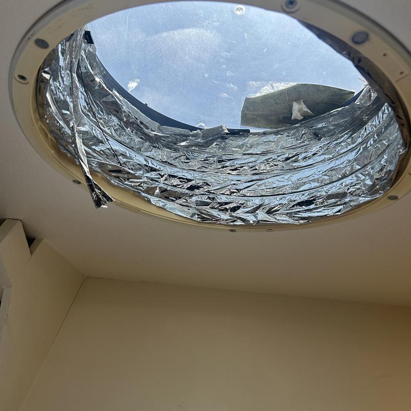 Solar tube ceiling fixture with damaged reflector foil