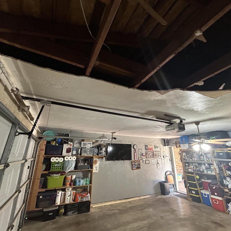 Garage ceiling sheetrock with water damage hole