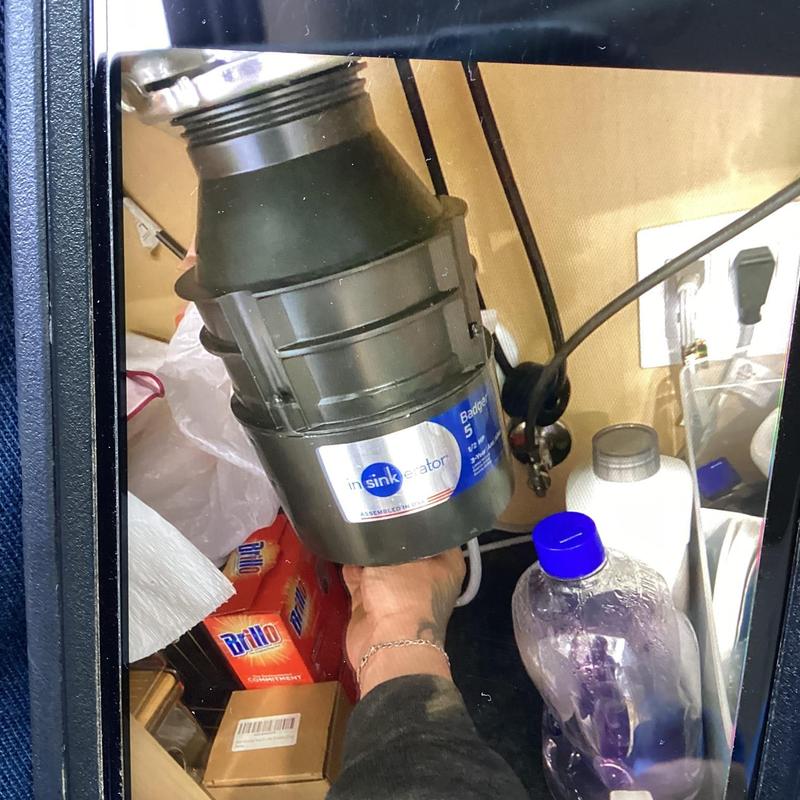 Garbage disposal unit under kitchen sink cleaning