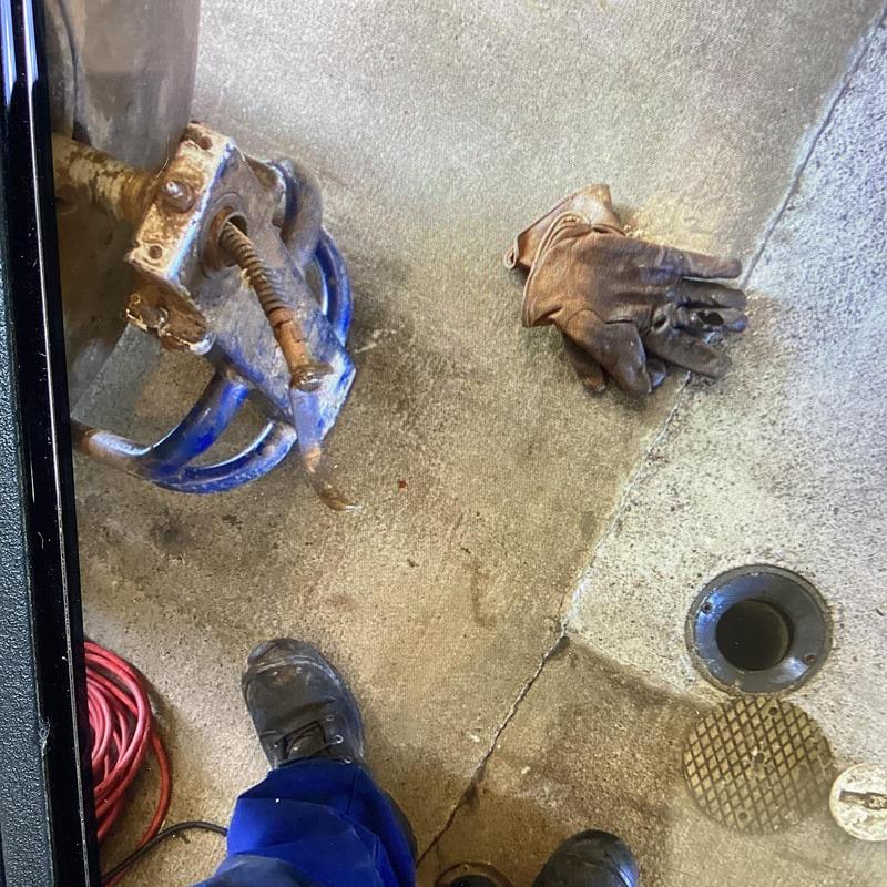 Mainline sewer drain with plumbing tools and gloves