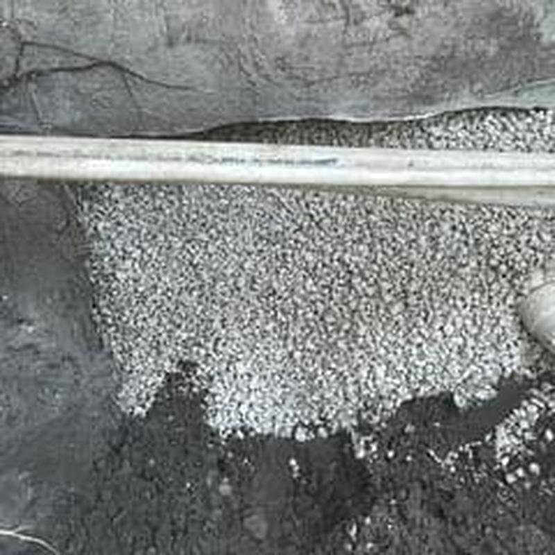 Sub-slab PVC drainage piping with stone backfill