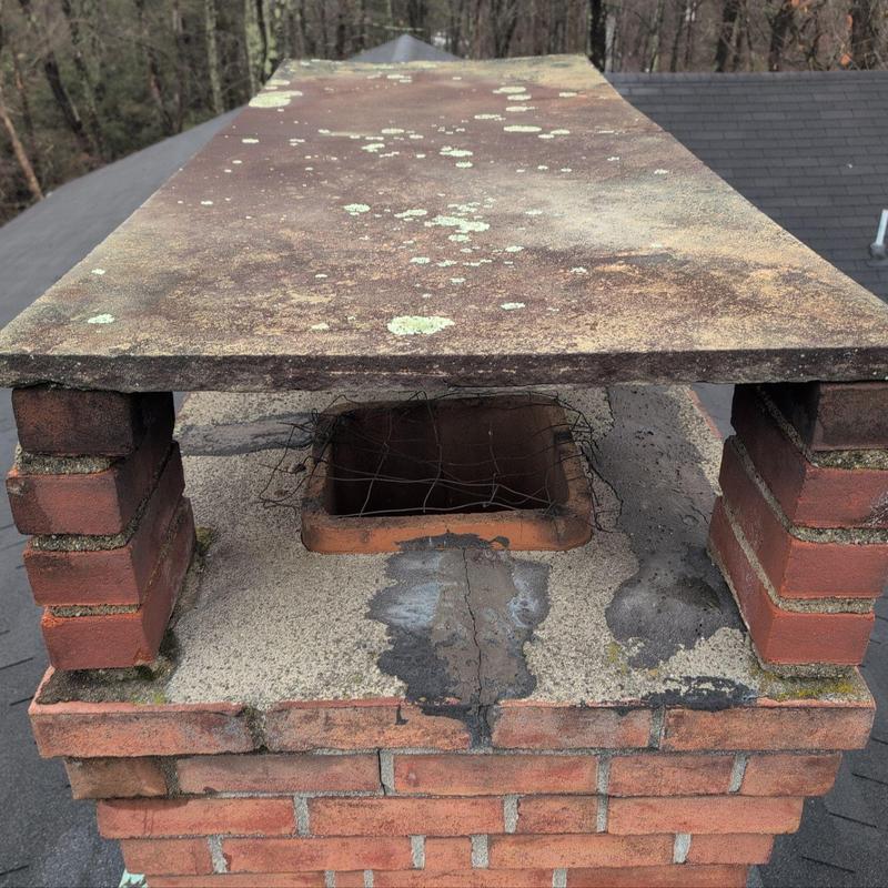 Chimney cap with rust and moss buildup Chimney cap with rust and moss buildup