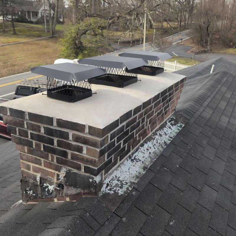 Chimney with new caps and repointed bricks on roof Chimney with new caps and repointed bricks on roof