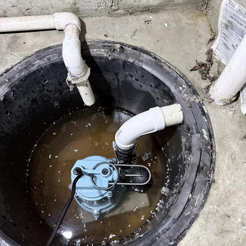 Sump pump with connected PVC drainage pipes