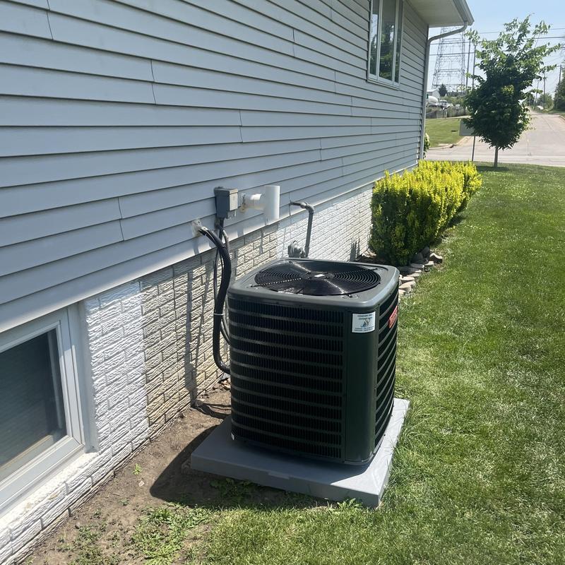 Central air conditioner unit installed outside home