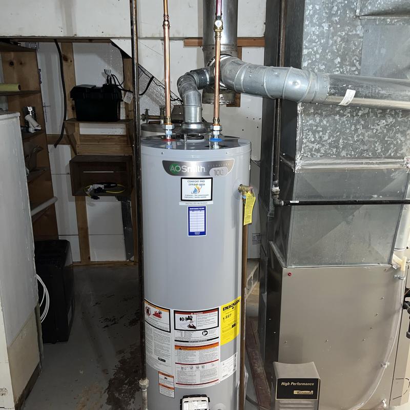 Water heater installation with vent pipes in basement