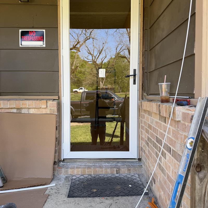 Storm door replacement with new white frame installed Storm door replacement with new white frame installed