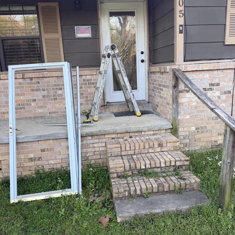 Storm door frame leaning by porch during replacement job Storm door frame leaning by porch during replacement job