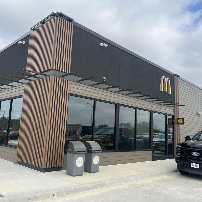 Restaurant exterior with trash bins and parking lot