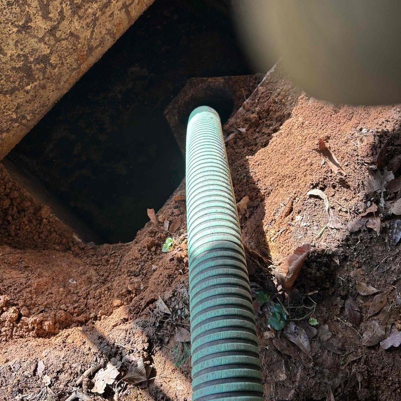 Septic tank excavation with green suction hose