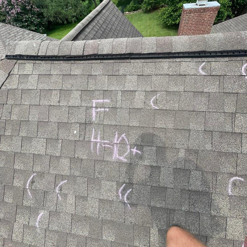 Asphalt shingle roof with hail damage markings