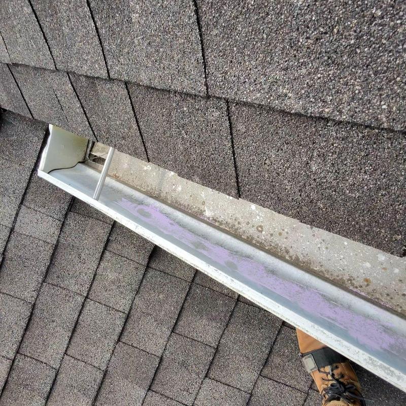 Metal flashing on shingled roof with visible wear