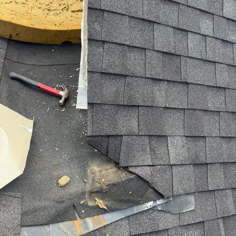Roofing shingles and underlayment with hammer nearby