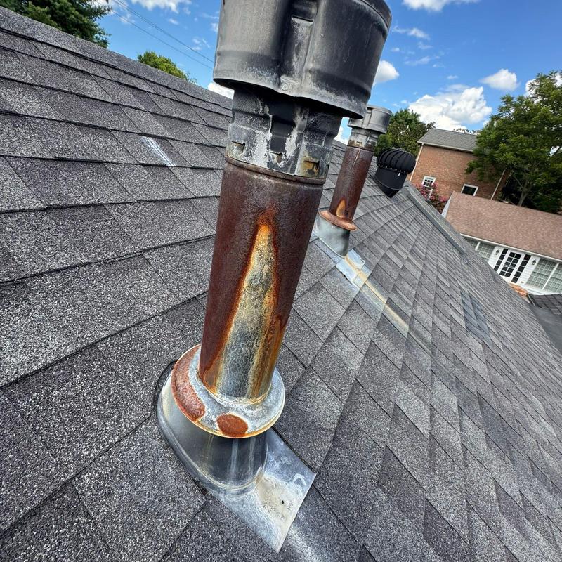 Rusty roof vent pipes on asphalt shingle roof