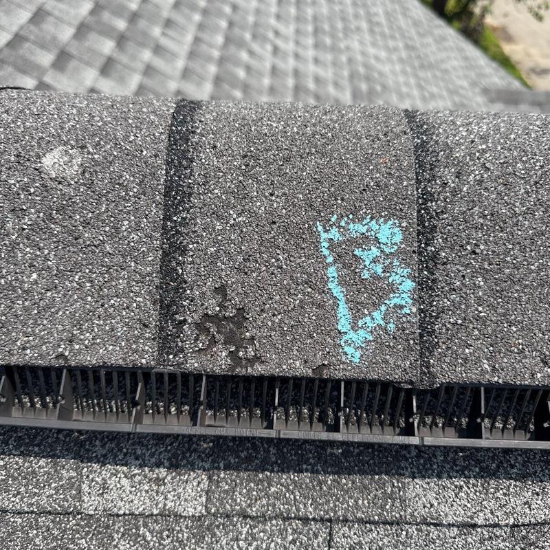 Architectural shingle with hail damage marked on roof edge
