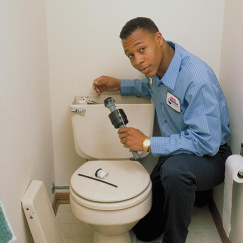 Toilet tank repair with plumber tools in commercial site