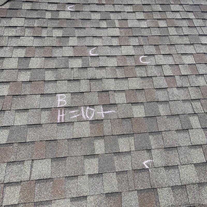 Asphalt shingle roof with hail damage markings