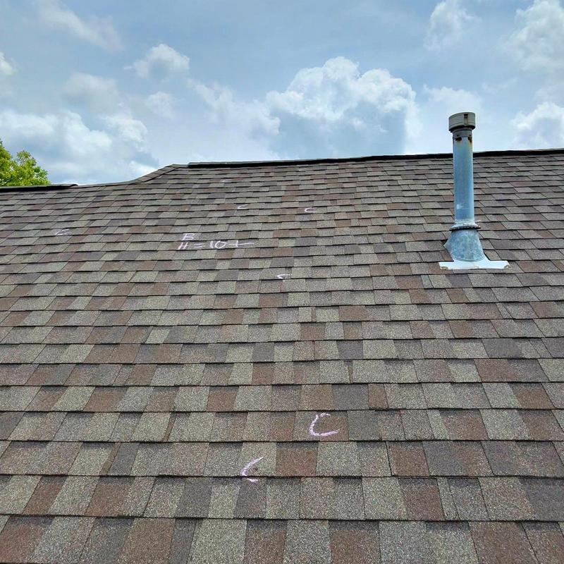 Asphalt shingle roof with hail damage markings