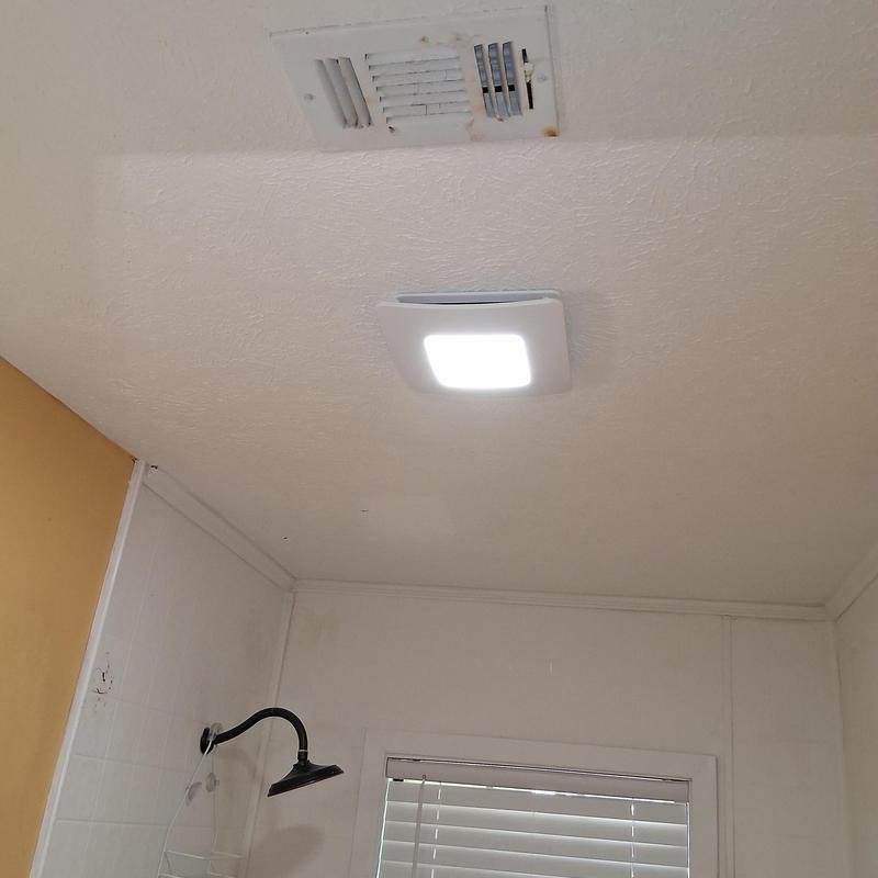 Exhaust vent fan with light installed on ceiling