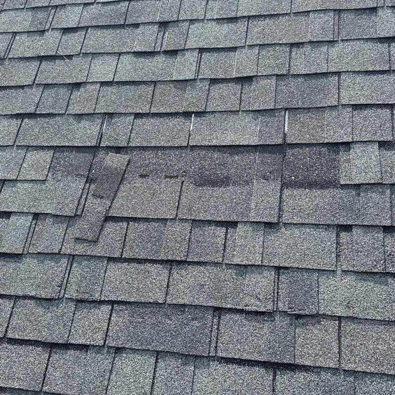 Asphalt shingles with visible damage and wear