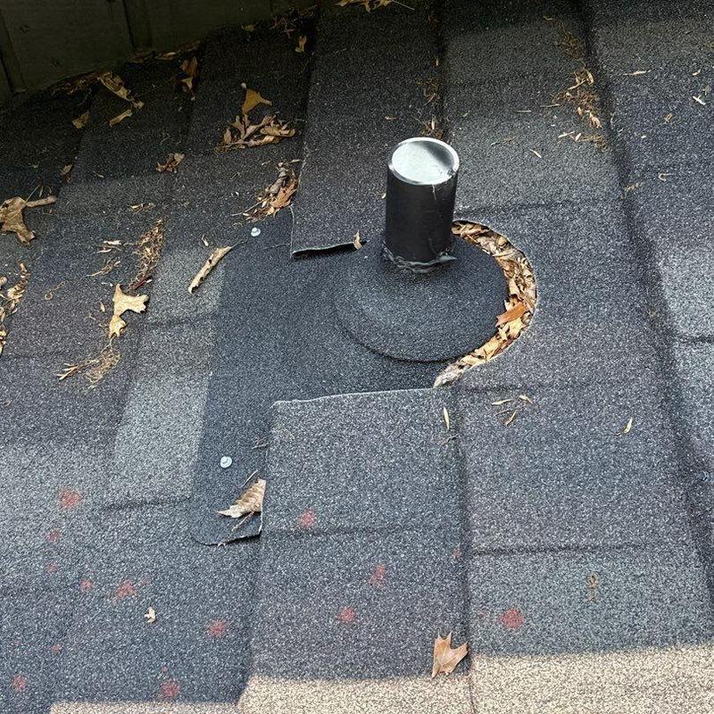 Roof shingles with hail damage near pipe flashing