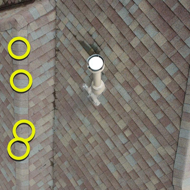 Roof shingles with hail damage marked in yellow circles