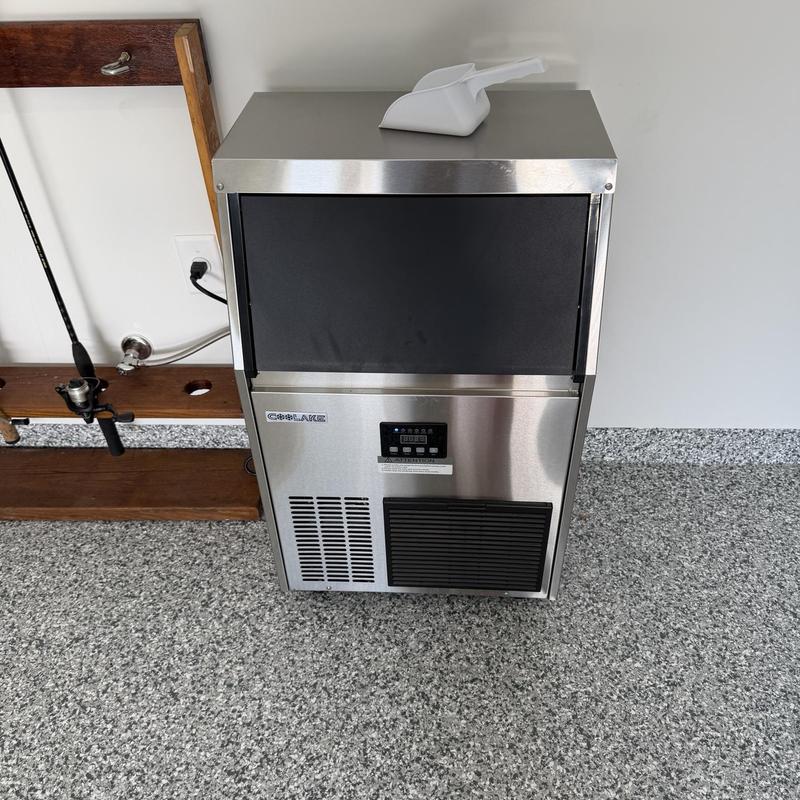 Stainless steel icemaker installed in garage area