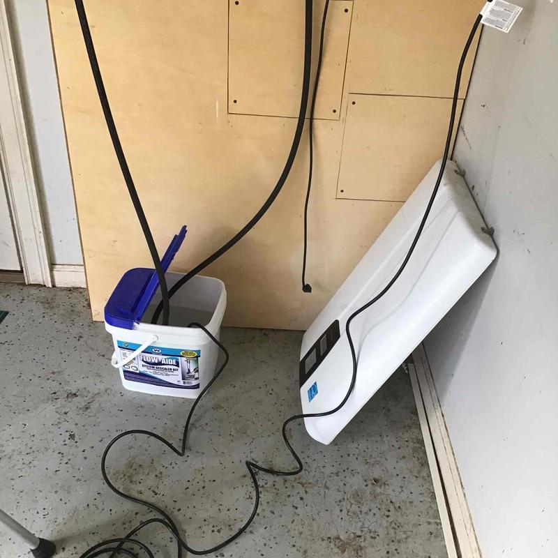 Tankless water heater flush system with cleaning solution