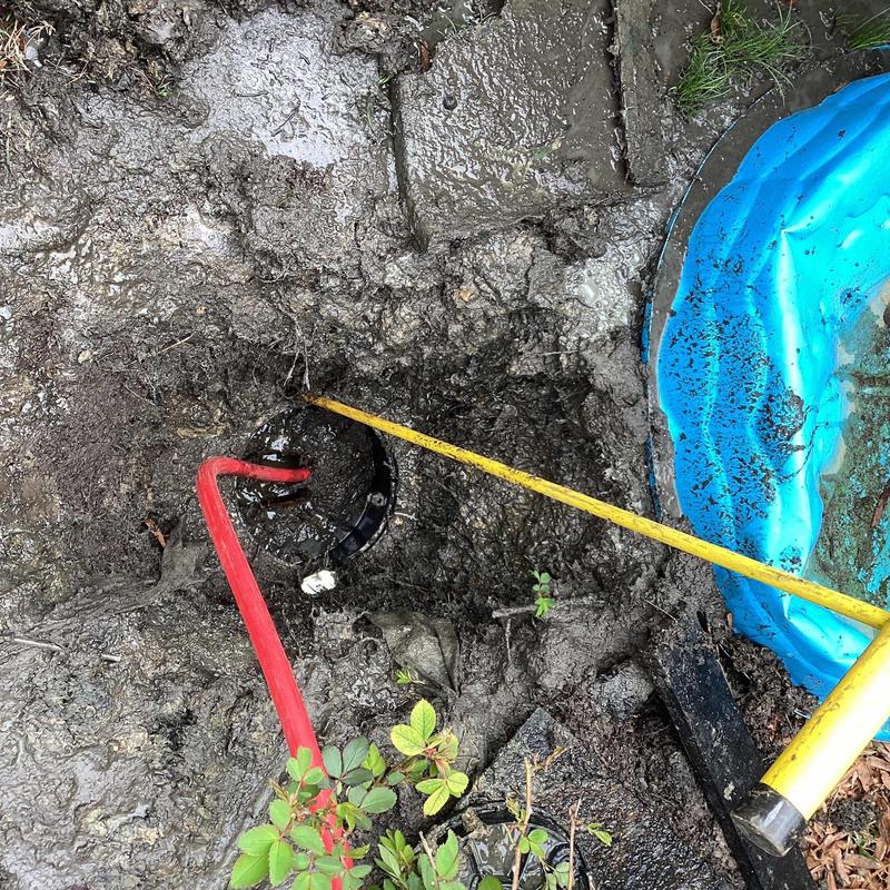 Sewer main jetting with cleaning tools in muddy trench