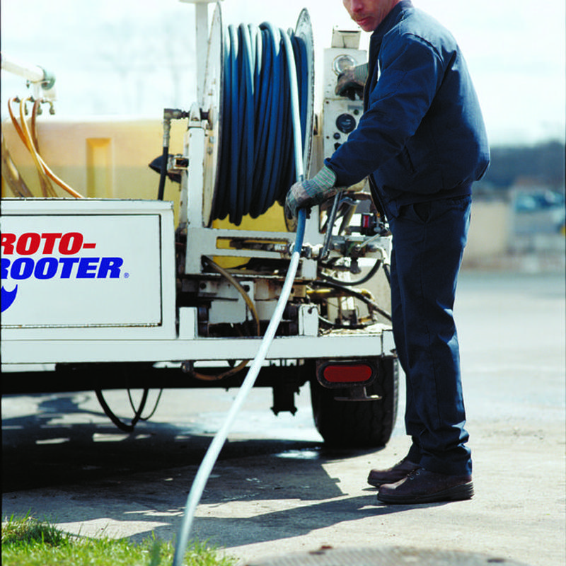 Commercial sewer line jetting with hose and machine