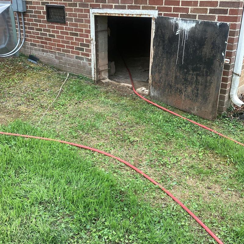 Jetted drain line access and hose at house exterior