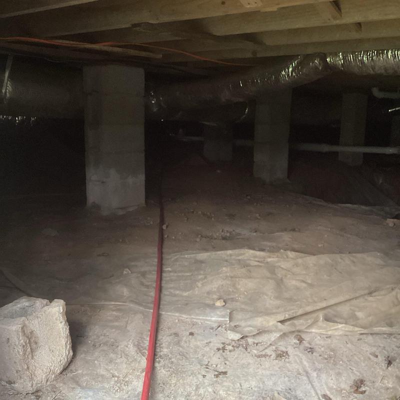 Sewer line jetting hose in crawl space under house