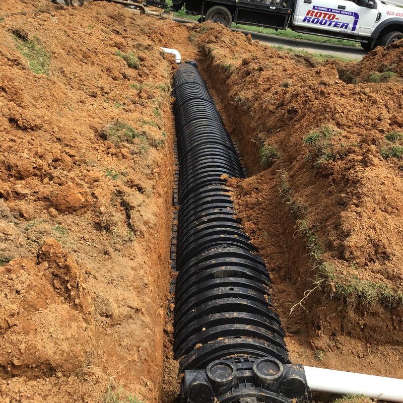 Drain field lines installation in trench with piping