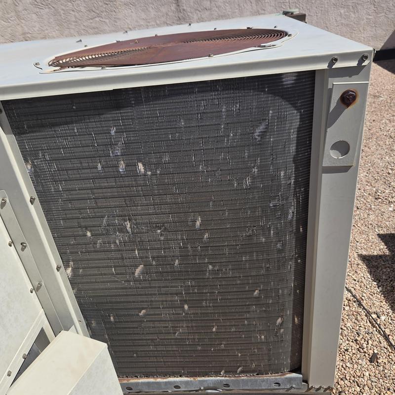Rooftop air conditioner condenser unit coil with debris