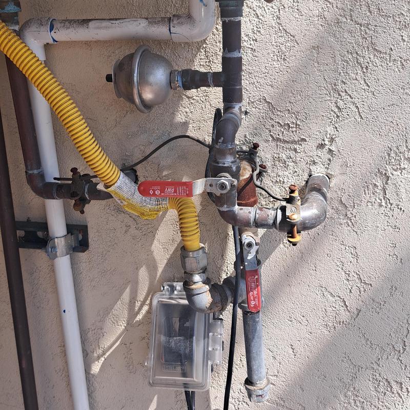 Gas meter and piping with valves on exterior wall