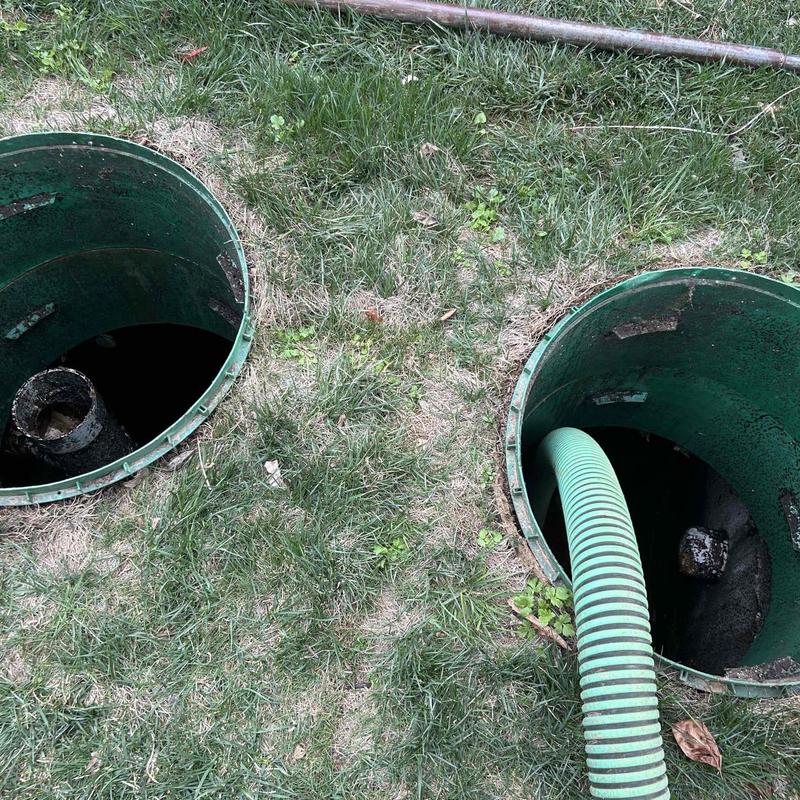 Septic tank openings with green suction hose