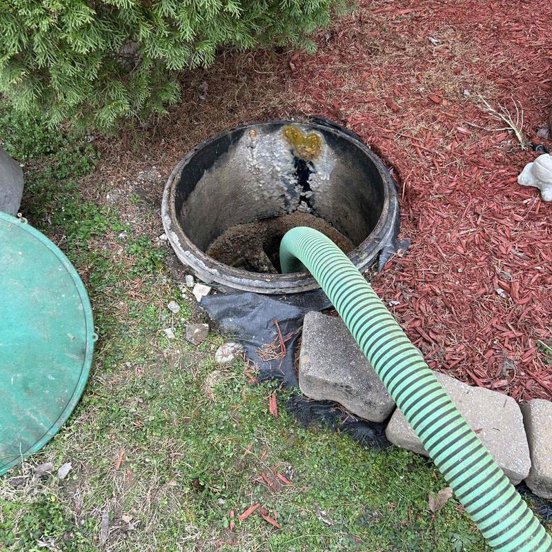 Septic tank riser with green suction hose