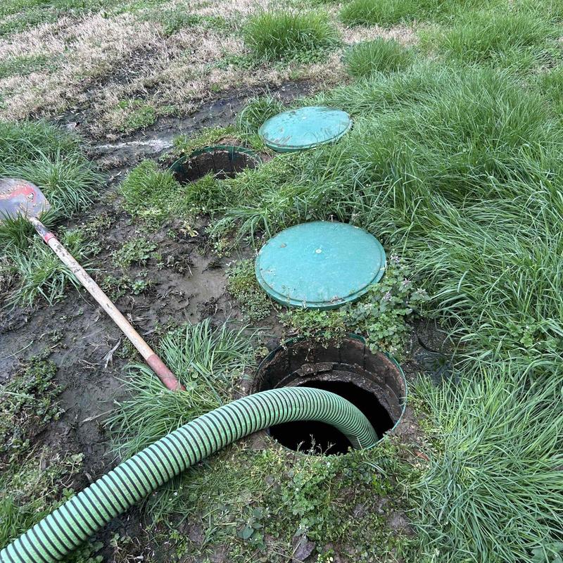 Septic tank riser with hose for pumping service
