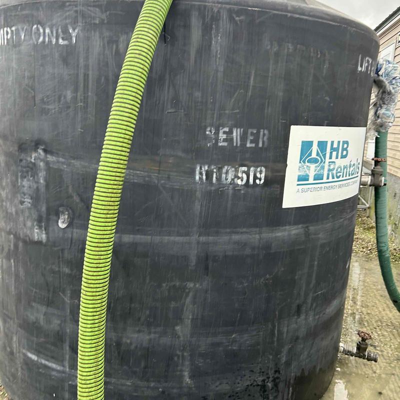 Holding tank with green suction hose attached