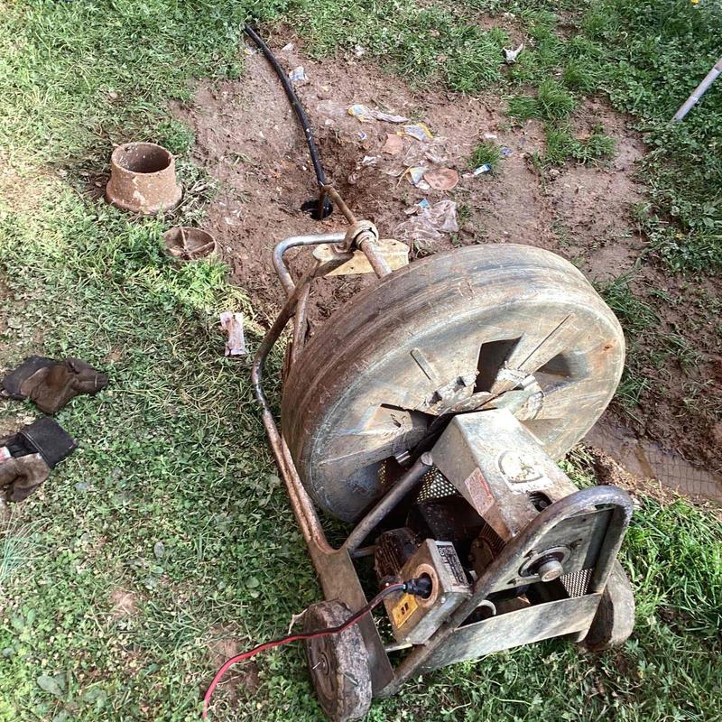 Mainline cable and sewer drum machine near clean out