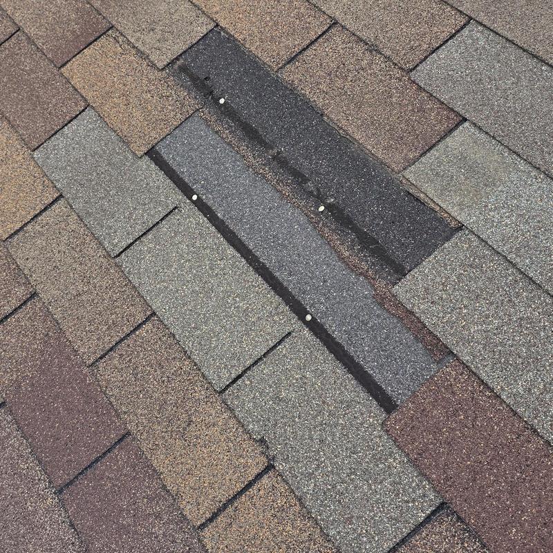 Asphalt shingles with hail damage and nail exposure