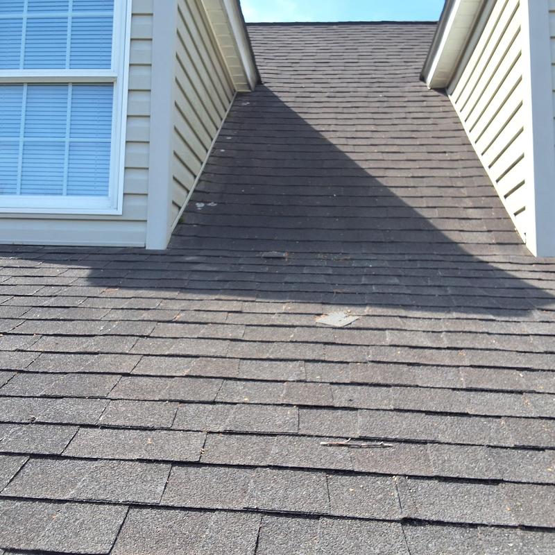 Asphalt shingle roof with visible wear near dormer walls