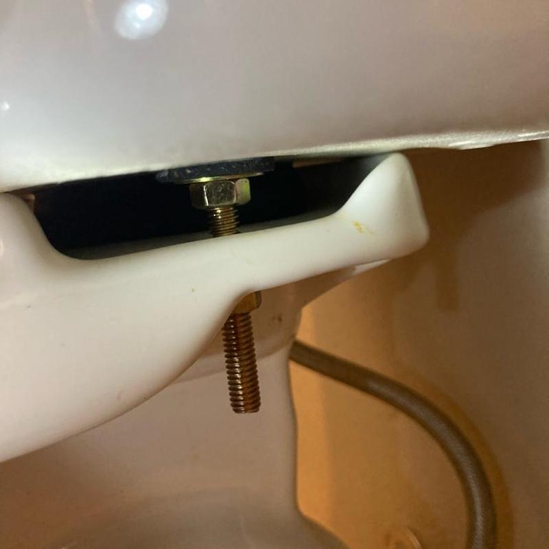 Toilet tank bolts and gasket installation close-up Toilet tank bolts and gasket installation close-up