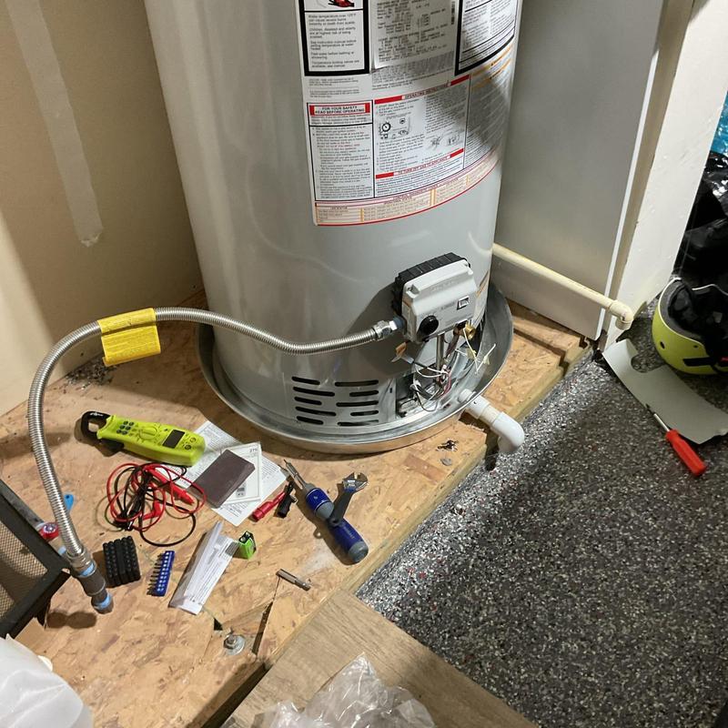 Gas control valve on water heater with tools nearby Gas control valve on water heater with tools nearby