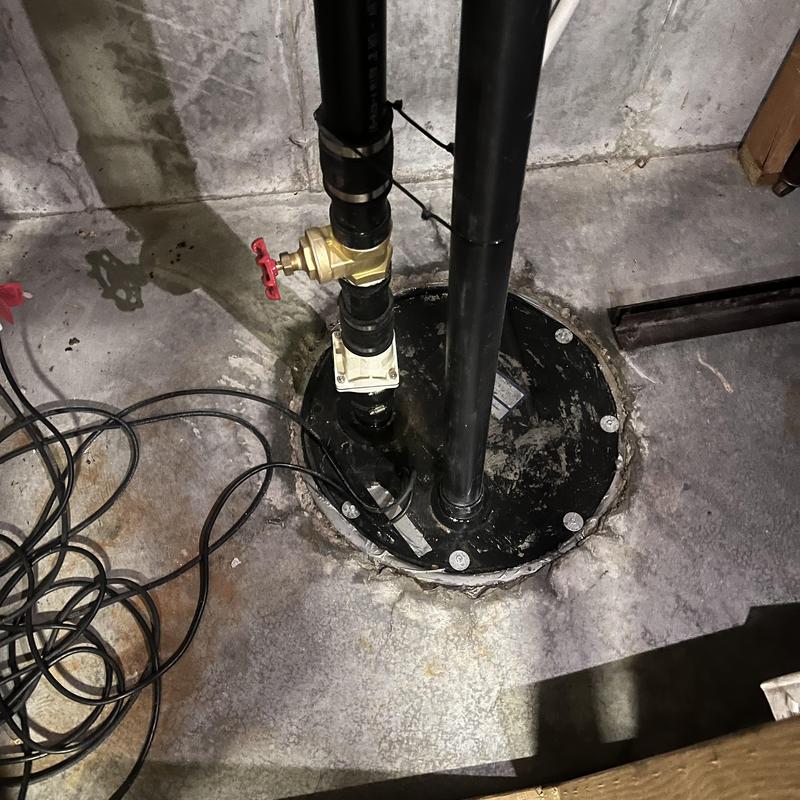 Sump pump system with valve and wiring in basement Sump pump system with valve and wiring in basement
