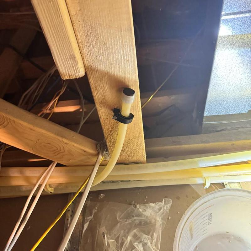 PEX plumbing repipe with capped hard water line in attic