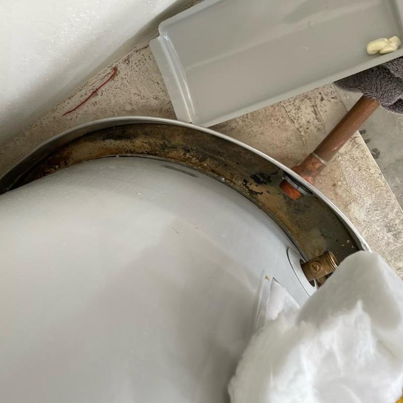 Water heater tank with rusted mounting base