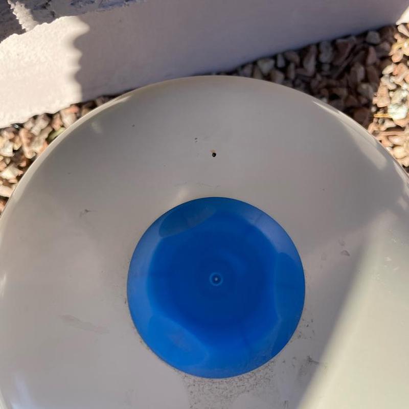 Water heater tank with small hole and blue cap