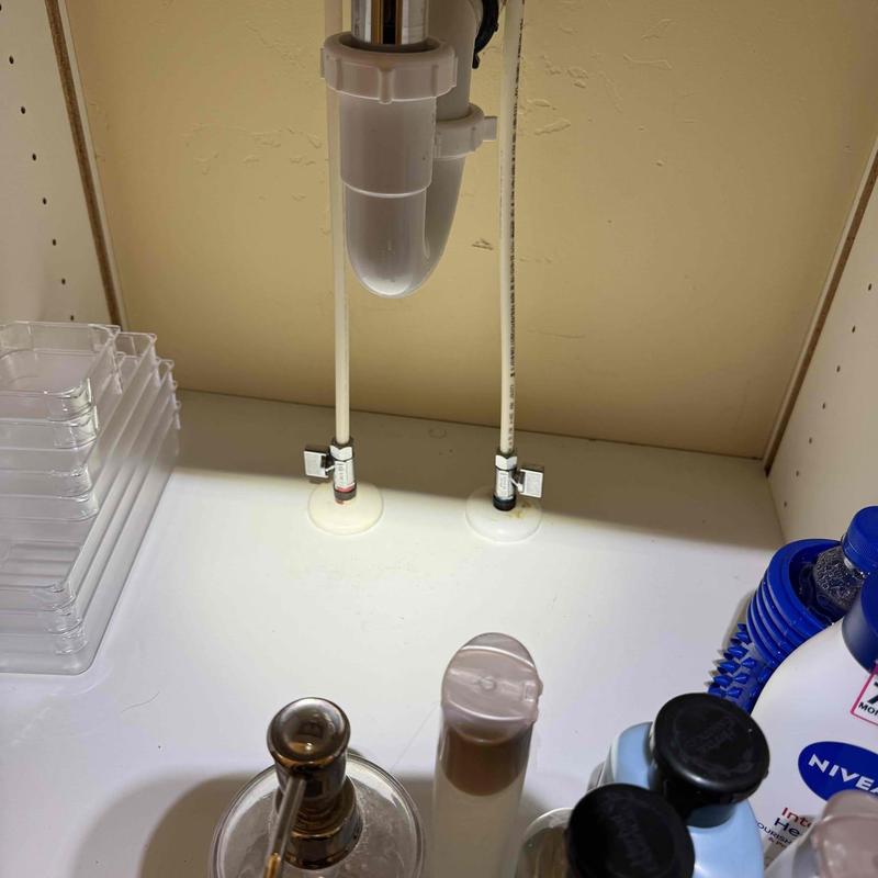 Sink drain pipe and water supply valves under cabinet
